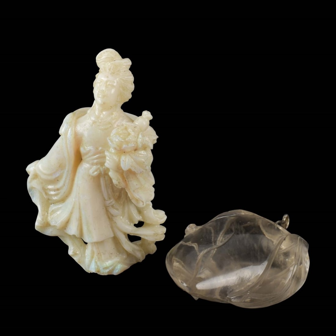 Carved Asian Sculptures: Two (2) Carved Asian Sculptures. One (1) rock crystal sculpture of a peach with leaves with ring for a hanging pendant, measures: 1-1/2" high, 1-1/4" wide, 3-4" deep, one (10 carved opal figure of a l