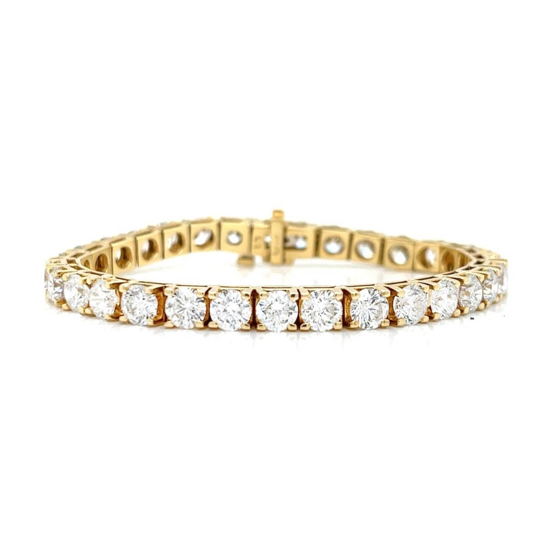 Diamond and 18K Tennis Bracelet: Vintage Approx. 16.0 Carat TW Thirty-one Round Brilliant Cut Diamond and 18 Karat Yellow Gold Tennis Bracelet. Diamonds G-H color, SI1-SI2 clarity. Measures 6-1/2" L. Approx. weight: 25.7 grams.