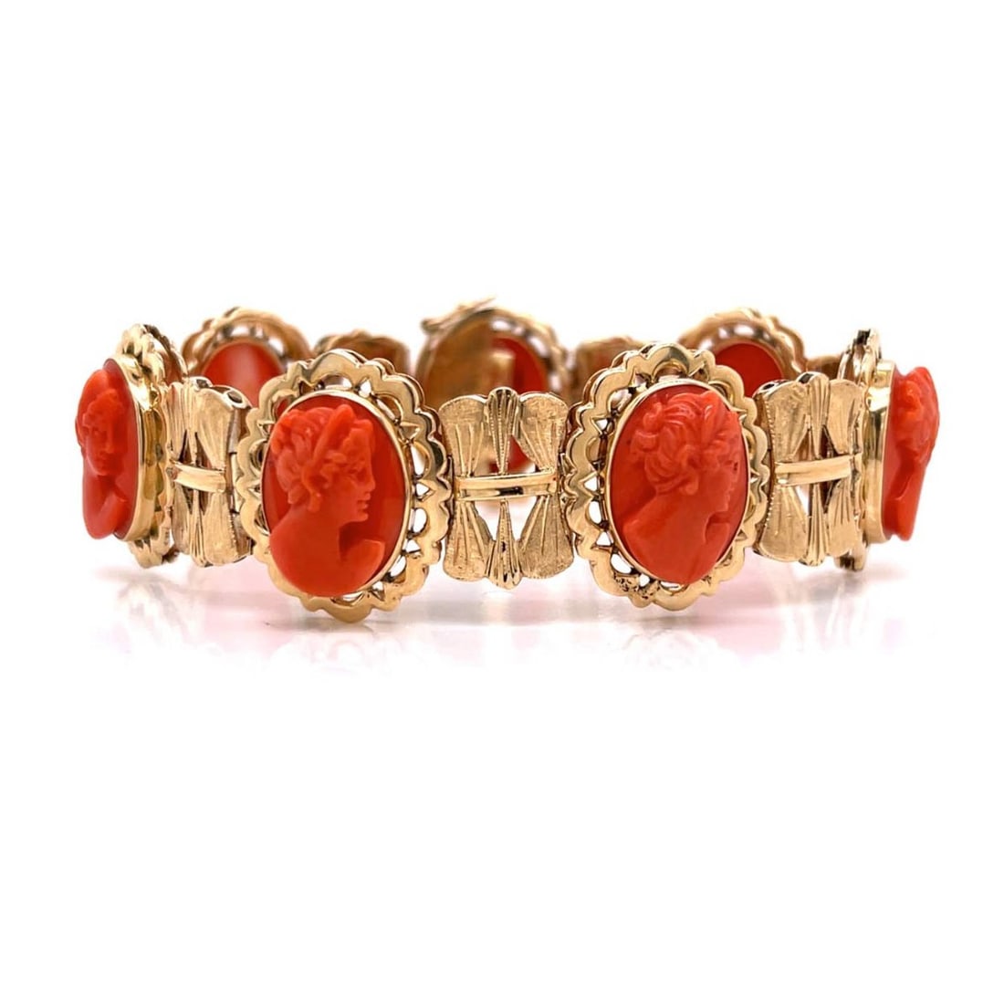 Red Coral and 18K Bracelet: Vintage Circa 1960s Carved Red Coral and 18 Karat Yellow Gold Link Bracelet. Measures 7-1/4" L. Approx. weight: 36.3 grams. Kodner Galleries offers phone and absentee bidding at a low, flat 21%