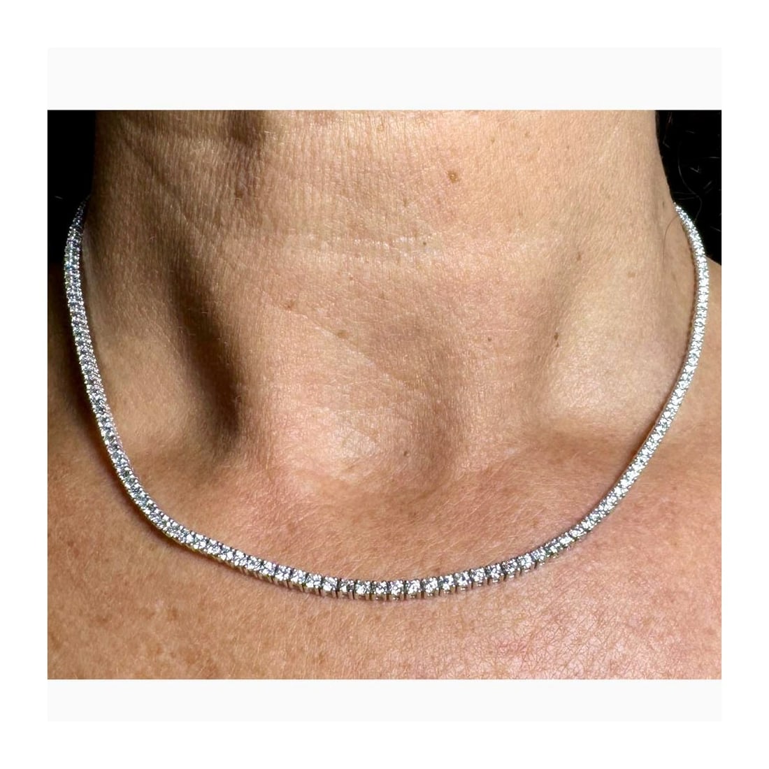 Diamond and 14K Tennis Necklace: Approx. 6.0 Carat TW One Hundred Eighty-two Round Brilliant Cut Diamond and 14 Karat White Gold Tennis Necklace. Diamonds F-G color, VVS1-VS2 clarity. Measures 16" L. Approx. weight: 12.0 grams.