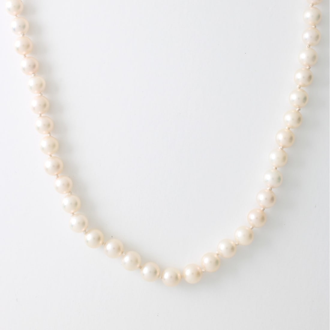 Fine Vintage Single Strand 6.4-6.5mm Pearl and 14: Fine Vintage Single Strand 6.4-6.5mm Pearl and 14 Karat Yellow Gold Necklace. Pearls with good luster and polish. Signed KGH and stamped 585 to clasp. Measures 18-1/4" L. Approx. weight: 23.94 grams.