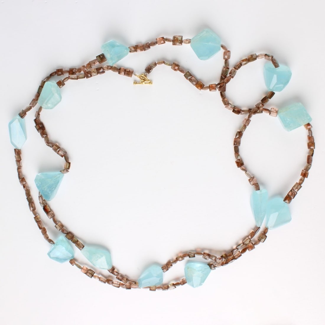 Aquamarine and Tourmaline Bead Necklace: Very Long Freeform Cut Aquamarine and Tourmaline Bead Necklace with 18 Karat Yellow Gold Clasp. Necklace measures 51" L. Approx weight: 114.27 grams. Kodner Galleries offers phone and absentee