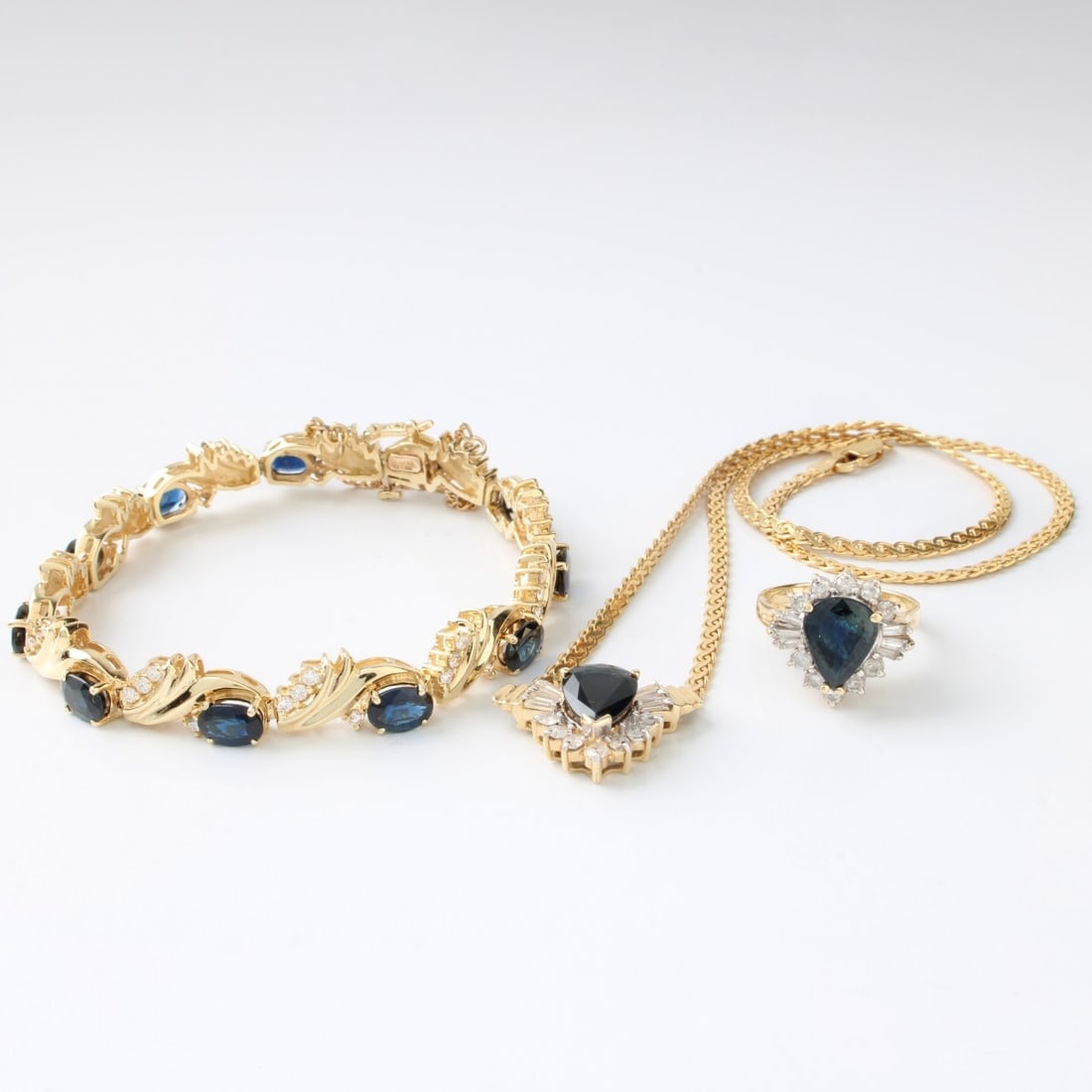 Sapphire, Diamond & 14K Jewelry Suite: Vintage Three (3) Piece Sapphire, Diamond and 14 Karat Yellow Gold Jewelry Suite. To include: a ring set with an approx. 2.50 carat pear shape sapphire and 1.0 carat TW round brilliant and baguette