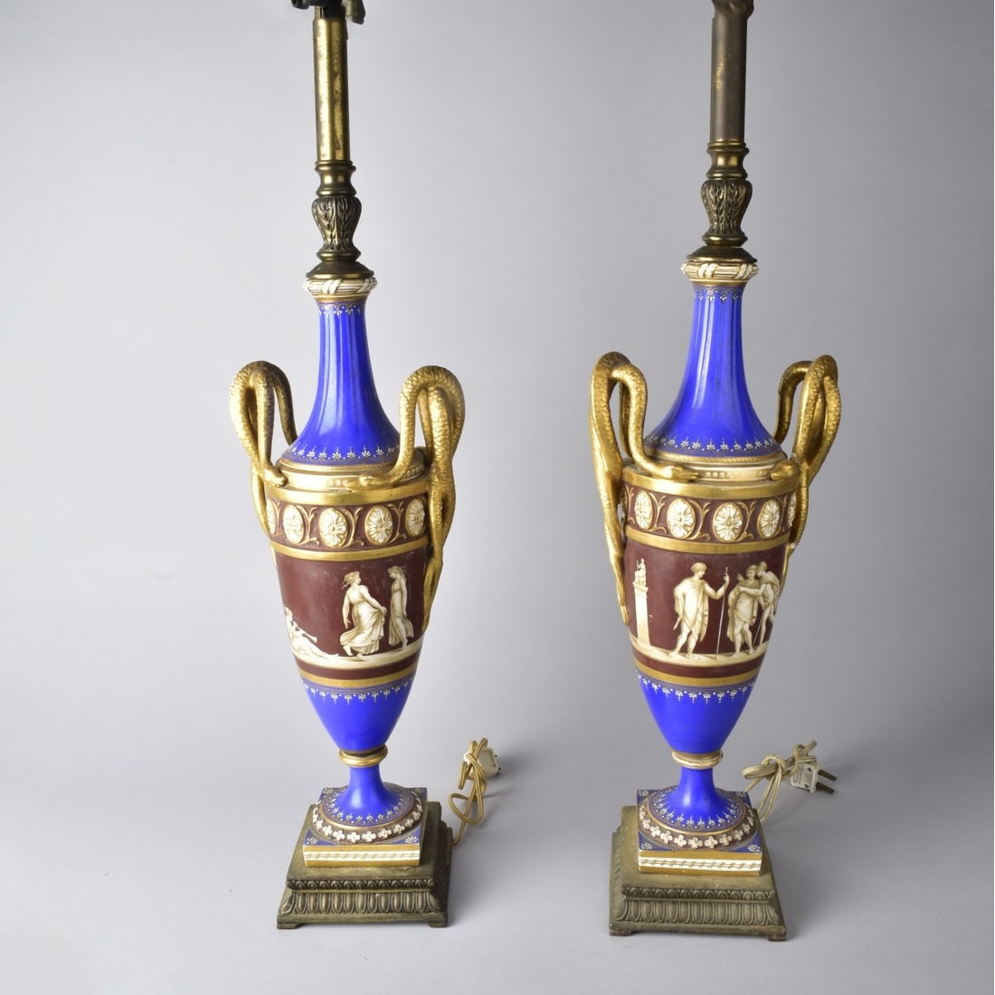 19C Old Paris Porcelain Urn Lamps: 19th Century Old Paris Porcelain Urn Lamps. Grecian center design with Cobalt Blue Accent and Gold Gilt Serpentine Handles. Lamps Measures 33"H. Urn with finial Measures 19-1/4"H x 7"W X 4"D. Kodner
