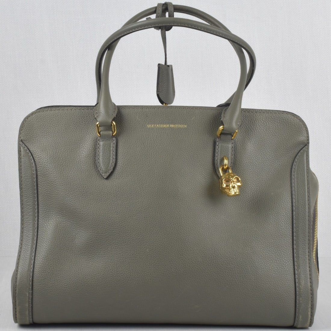 Alexander McQueen Handbag: Alexander McQueen Green Calfskin Handbag with Gold Tone Hardware. Measures: 10" high, 14-1/2" wide, 8" deep, drop measures: 8-1/4". Kodner Galleries offers phone and absentee bidding at a low, flat