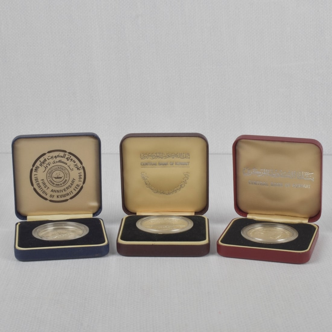 Kuwait Silver Commemorative Coins: Three (3) Kuwait Silver Commemorative One (1) Ounce Coins in Sealed Cases and Presentation Boxes. Years 1981, 1986 and 1991. Kodner Galleries offers phone and absentee bidding at a low, flat 21%