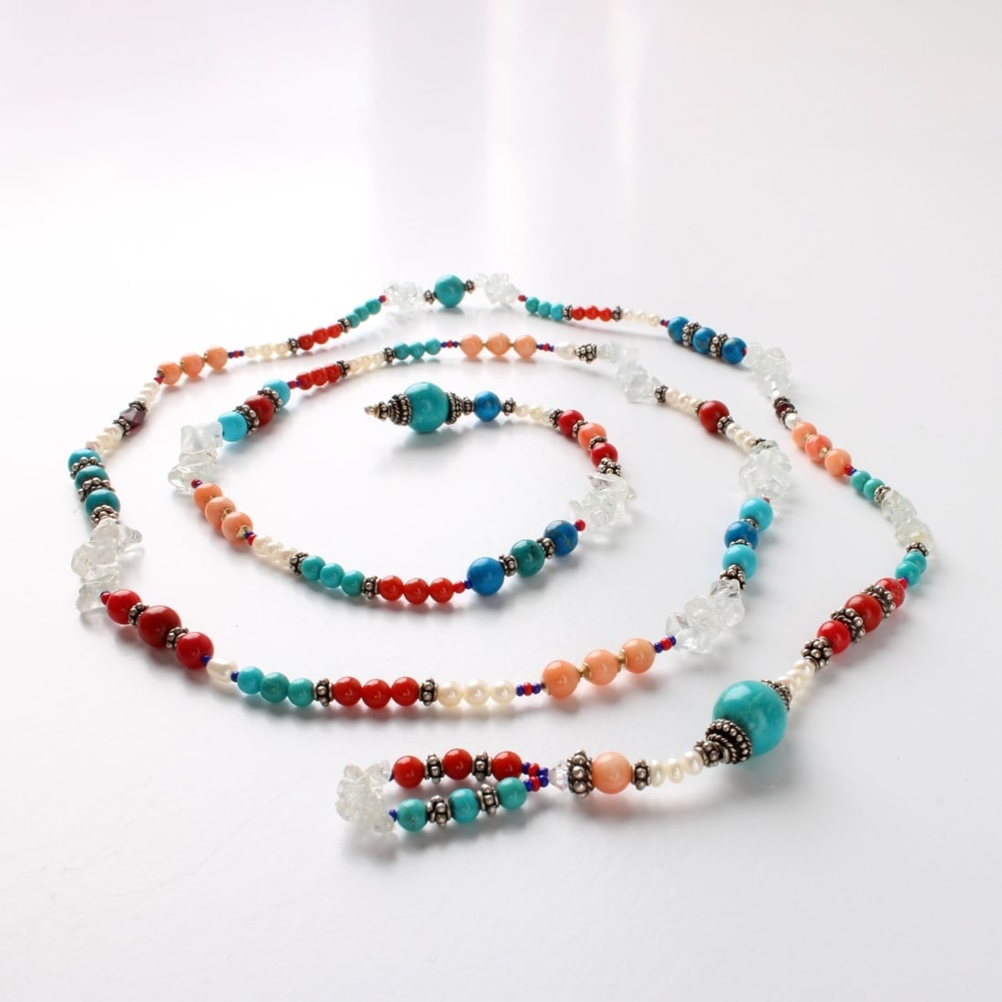 Hardstone and Silver Necklace: Vintage Hardstone Bead, Crystal Nugget and Silver Lariat style Long Necklace. Set with turquoise, red and pink coral, pearl and black onyx beads. Measures 38" L. Approx. weight: 44.71 grams. Kodner