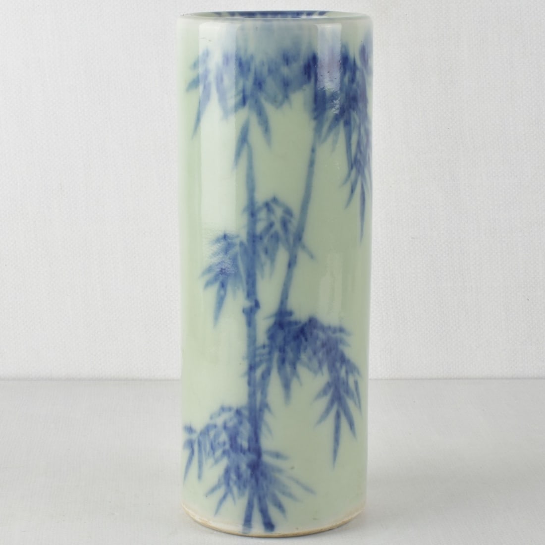 Chinese Porcelain Hat Stand: Antique Chinese Glazed Porcelain Hat Stand Decorated with Blue Bamboo on a Green Ground. Measures: 12-1/4" high, 4-5/8" diameter. Kodner Galleries offers phone and absentee bidding at a low, flat 21%