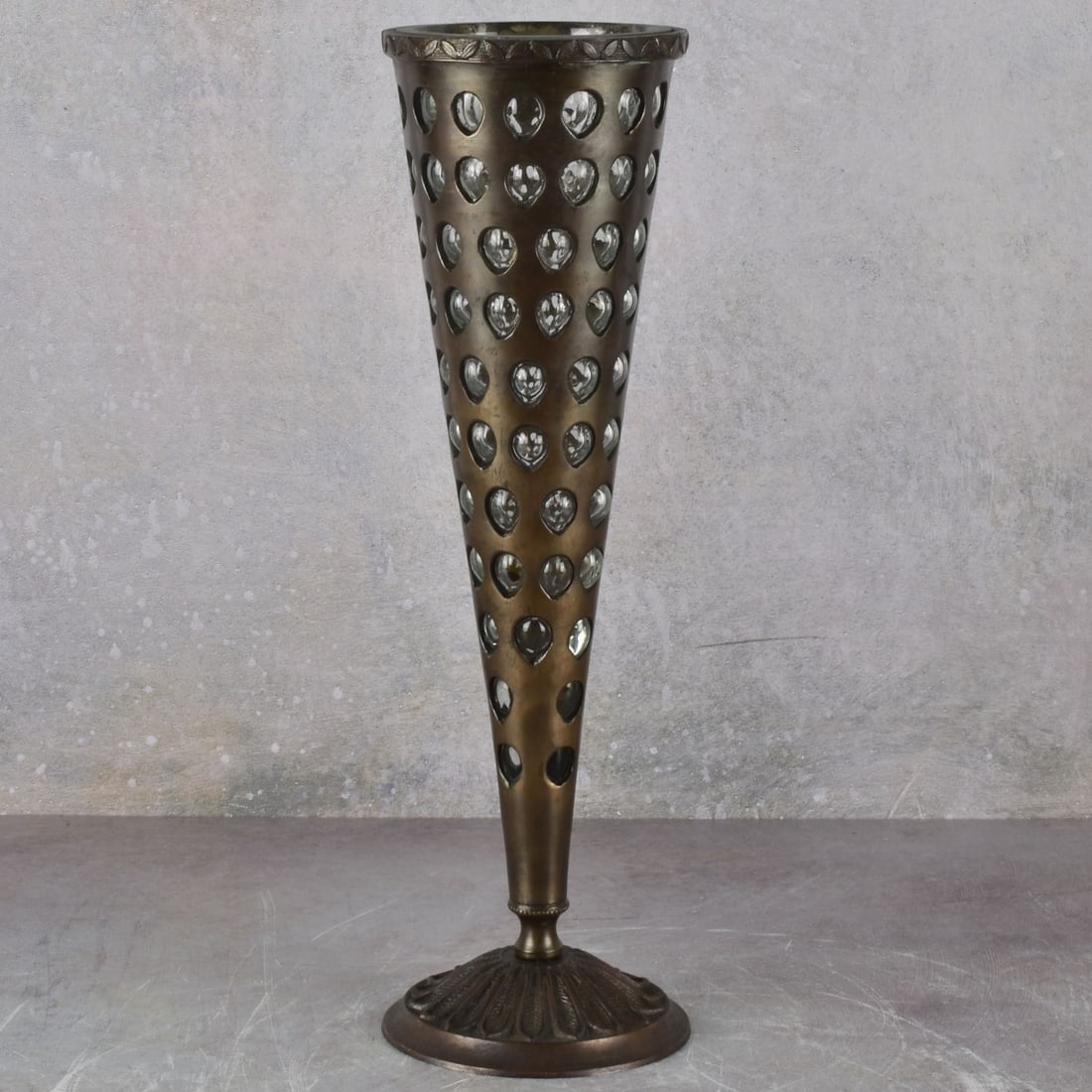 Patinated Bronze with Inlaid Glass Vase: Vintage Heavy Patinated Bronze with Caged Glass Elements Cone Shape Vase with an Acanthus Leaf Circular Foot Base. Measures: 14-1/4" high, top measures: 4-1/4" diameter. Kodner Galleries offers phone