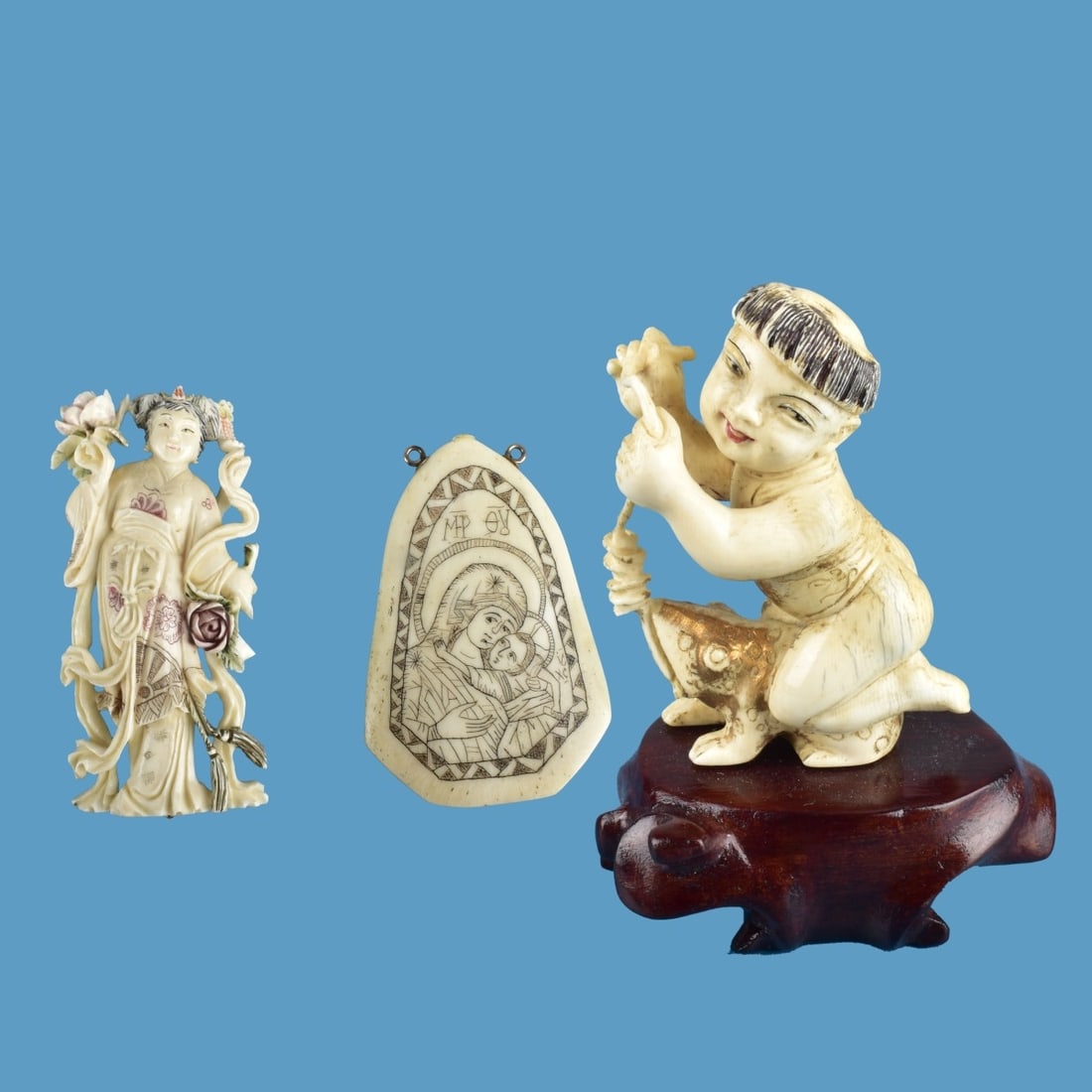 Three Assorted Carved Items: Lot of Three Assorted Carved Items. Includes a Chinese polychrome painted figurine of a young child riding a frog presented on a wooden base, Chinese polychrome painted Guanyin figural brooch, and a R