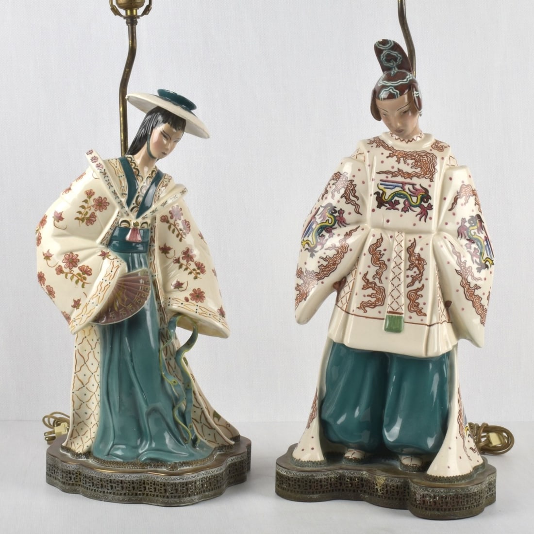 Le Bertetti Porcelain Lamps: Pair of Le Bertetti Mid-20th Century Japanese Polychromed Porcelain Figural Lamps on Reticulated Metal Bases and Recent Finials. Tallest figure measures: 20-1/2" high. Kodner Galleries offers phone