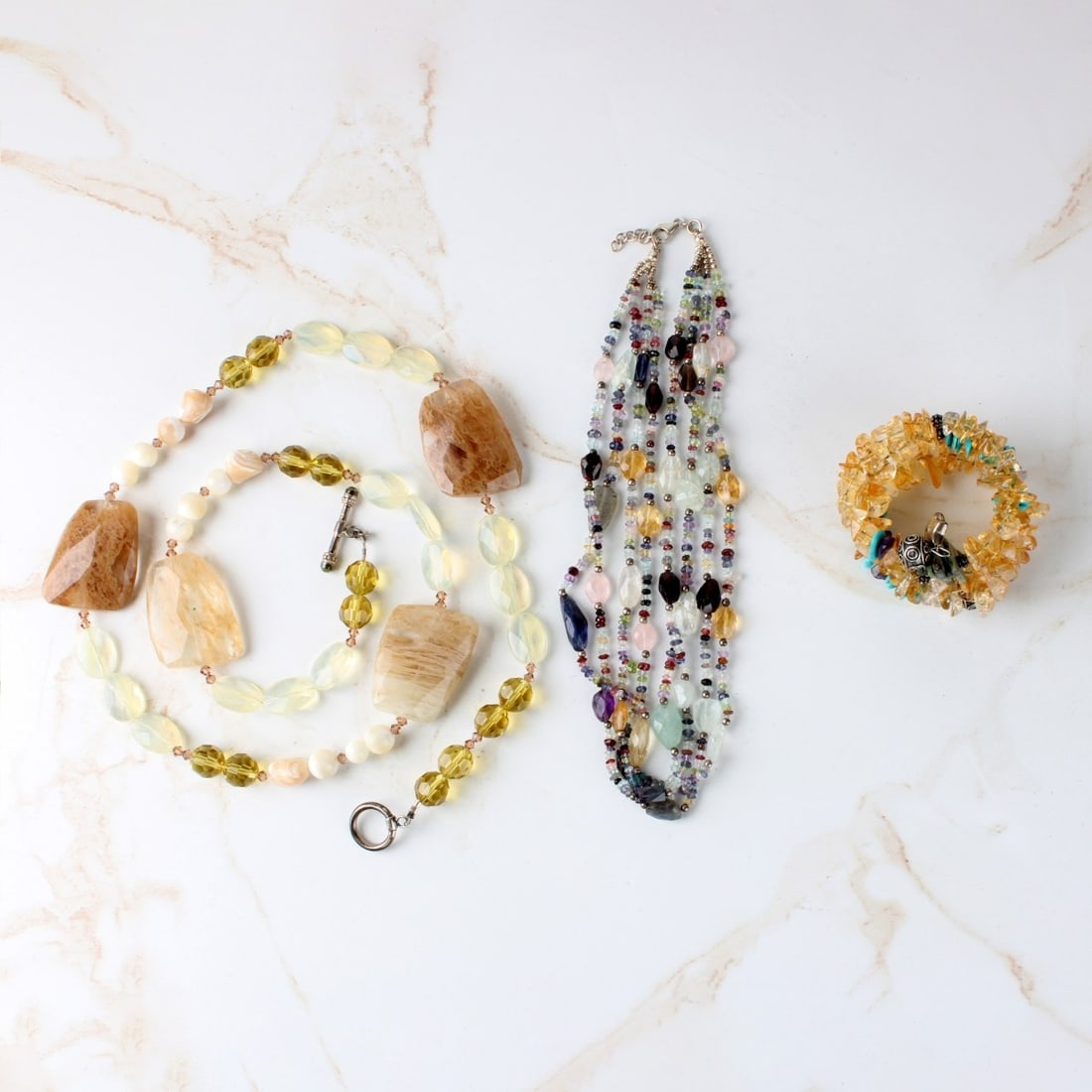 Natural Gemstone and Hardstone Jewelry: Natural Gemstone and Hardstone Jewelry. Including two (2) necklaces, measures: 33" long, one (1) curling bracelet. Kodner Galleries offers phone and absentee bidding at a low, flat 21% buyer?s