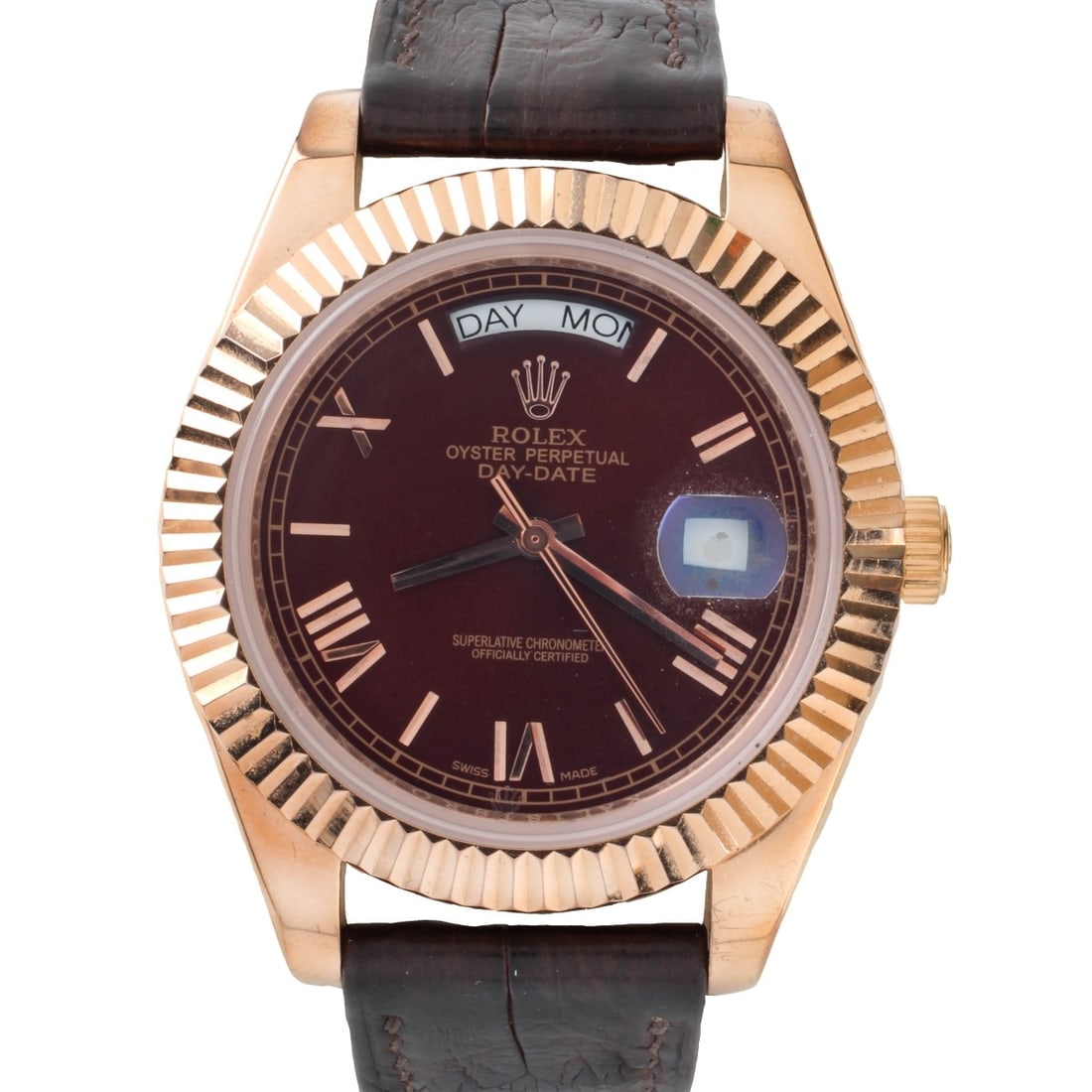 Rolex Day Date Clone Watch: Rolex Clone Presidential Day Date Rose Tone Stainless Steel Watch with Brown Leather Strap Bracelet. Automatic movement. Case measures 41mm. Bracelet measures 9-3/8" L. Kodner Galleries offers phone