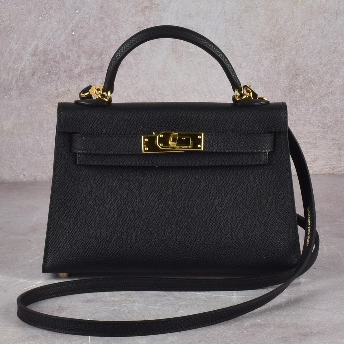 Replica Hermes Mini Black Leather Bag: Replica Hermes Mini Black Leather Bag with Long Detachable Shoulder Strap and with Gold Tone Hardware. Use as a handbag, should bag or a crossbody with box. Measures: 4-3/4" high,7-1/2 wide, gusset