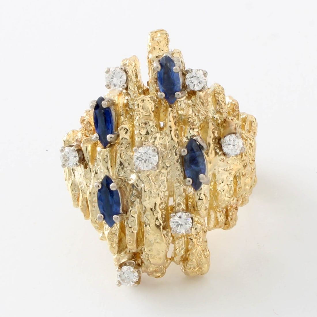 Sapphire, Diamond and 18K Ring: Vintage Retro Modern Marquise Shape Sapphire, Round Brilliant Cut Diamond and Textured 18 Karat Yellow Gold Ring. Ring size 5. Approx. weight: 16.03 grams. Kodner Galleries offers phone and absentee b