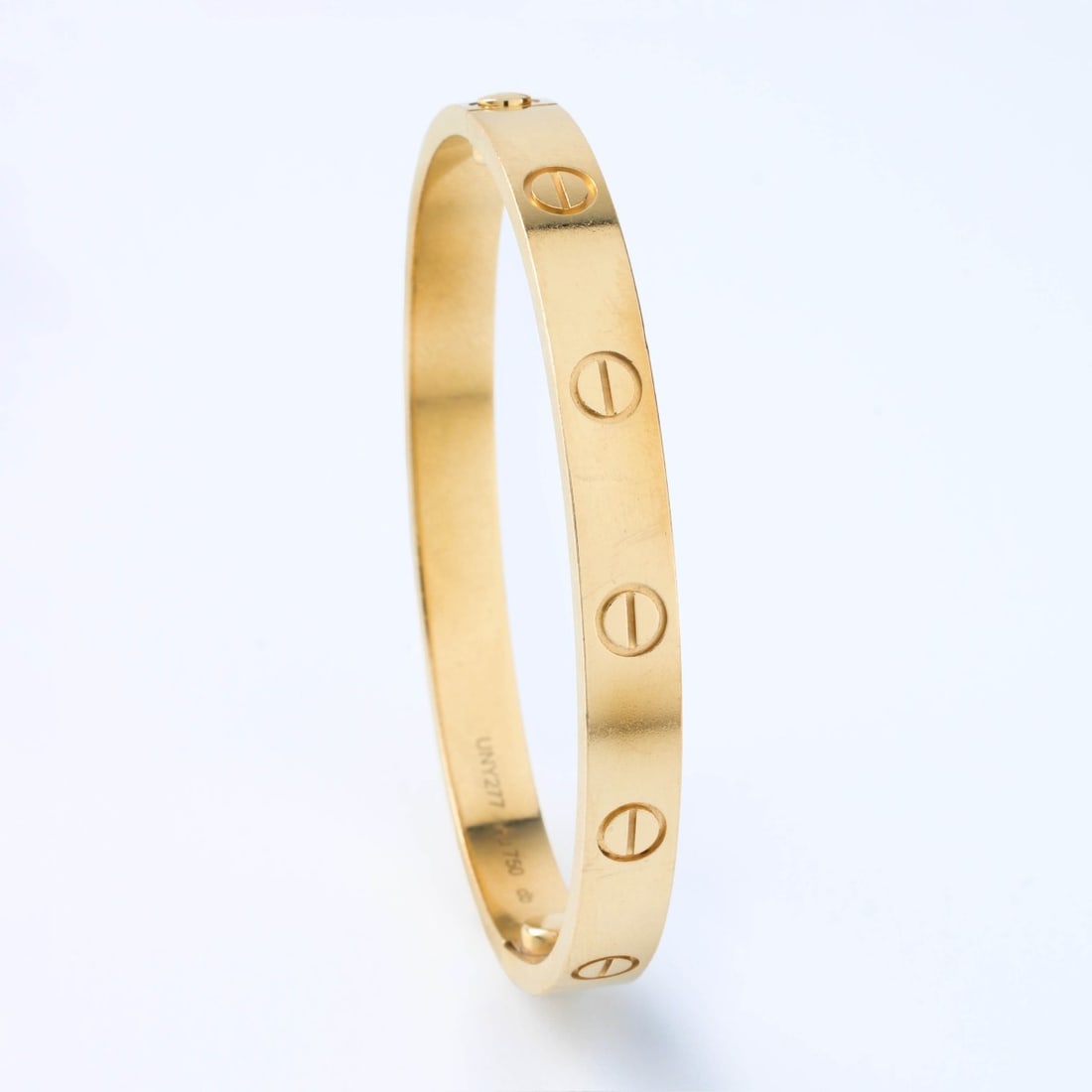 Cartier 18K Love Bracelet: Vintage Cartier 18 Karat Yellow Gold Love Bracelet. Cartier size 16, US size 6.29 inch circumference. Signed, stamped AU750, numbered UNY277. With Cartier box, papers and screwdriver. Approx. weight: