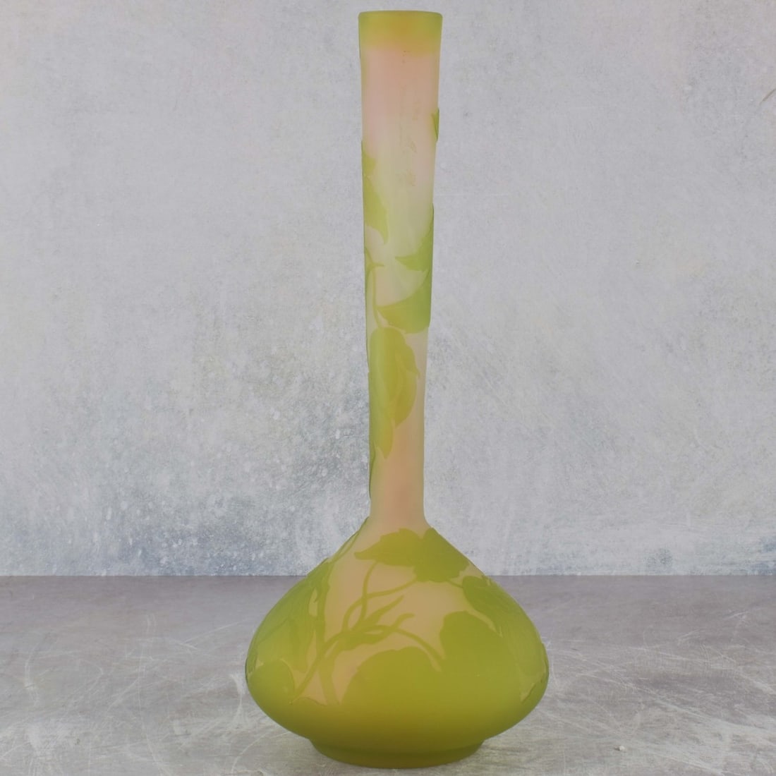 Galle Cameo Glass Vase: Emile Galle French Cameo Glass Solifore Long Neck Vase Depicting a Green Floral Motif in a Bulbous Bottom Circa 1900. Signed "Galle" in cameo to the side. Measures: 12" high, 4-1/4" diameter. Kodner
