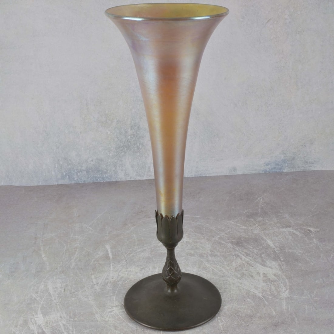 Tiffany New York Gold Aurene Glass: Tiffany New York Gold Aurene Glass Trumpet Vase with Bronze Foliate Foot Circa 1910. Bottom plate signed "Tiffany Studios New York 1043" glass signed "L.C.T. Favrile". Measures: 15" high, foot