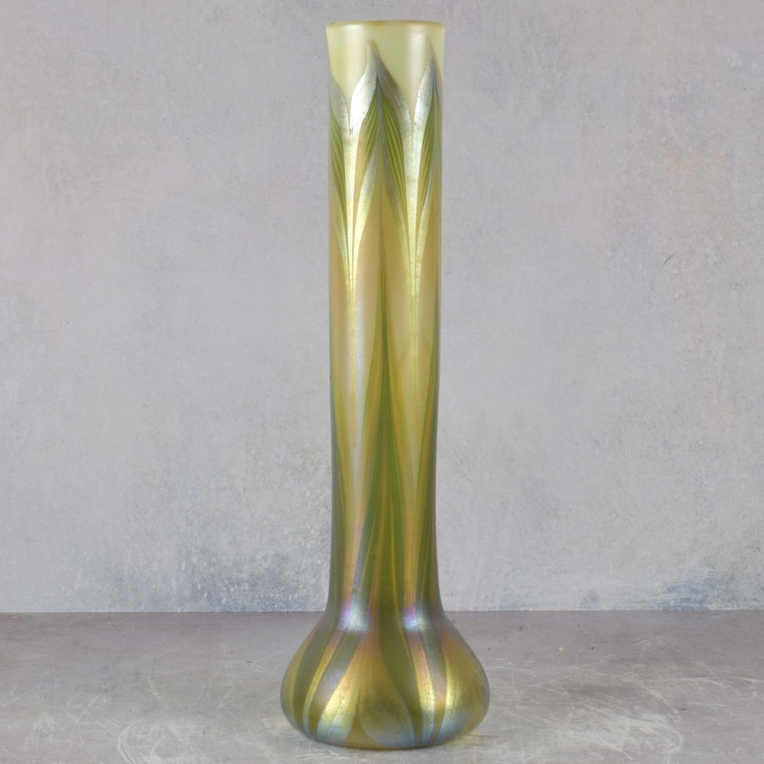 L. C. Tiffany Pulled Feather Glass Vase: L.C. Tiffany Pulled Feather Vase Circa 1900. Signed "L.C. T. - Y 9855" to the bottom . Measures: 17-3/4" high, 5" diameter. Kodner Galleries offers phone and absentee bidding at a low, flat 21%