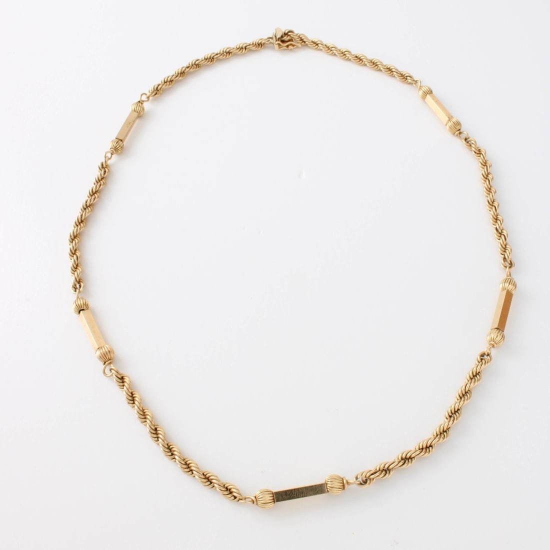 14K Necklace: Vintage 14 Karat Yellow Gold Rope and Bar Chain Necklace. Stamped 14K. Measures 18" L. Approx. weight: 9.0 grams. Kodner Galleries offers phone and absentee bidding at a low, flat 21% buyer?s premium