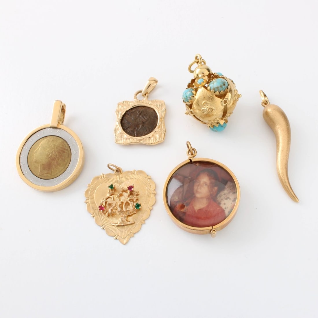 14K Pendants / Charms: Collection of Seven (7) 14 Karat Yellow Gold Pendants/ Charms. Most stamped 14K, one stamped 750. Approx. total weight: 9.6 grams. Kodner Galleries offers phone and absentee bidding at a low, flat