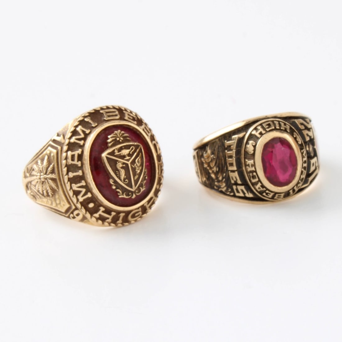 10K Class Rings: Two (2) Vintage 10 Karat Yellow Gold Class Rings Accented with Man Made Rubies. Stamped 10K. Approx. total weight: 9.12 grams. Kodner Galleries offers phone and absentee bidding at a low, flat 21% buy