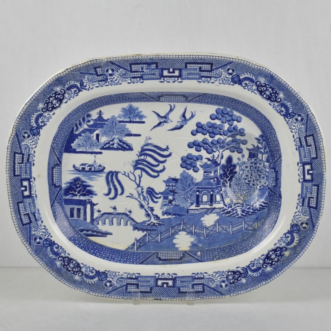 Victorian English Meat Tray: Victorian English Davenport Blue Willow Earthenware Meat Platter with Juice Well. Having a Chinoiserie design featuring a Chinese legend of two lovers who are transformed into birds. Marked to the