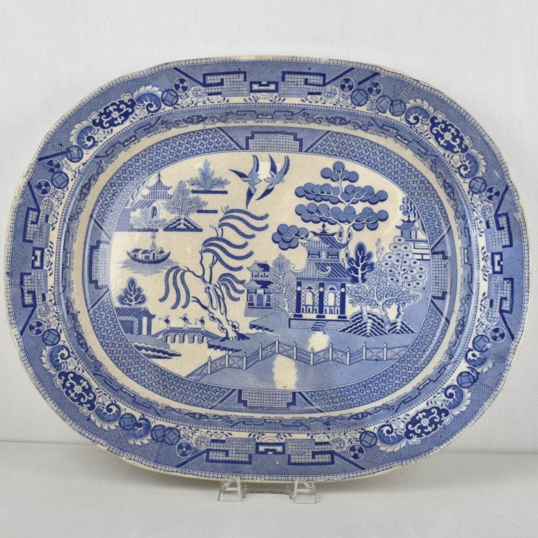 Victorian English Serving Platter: Victorian English Most Likely Davenport Blue Willow Earthenware Platter. Having a Chinoiserie design featuring a Chinese legend of two lovers who are transformed into birds. Measures: 23-1/2" wide,