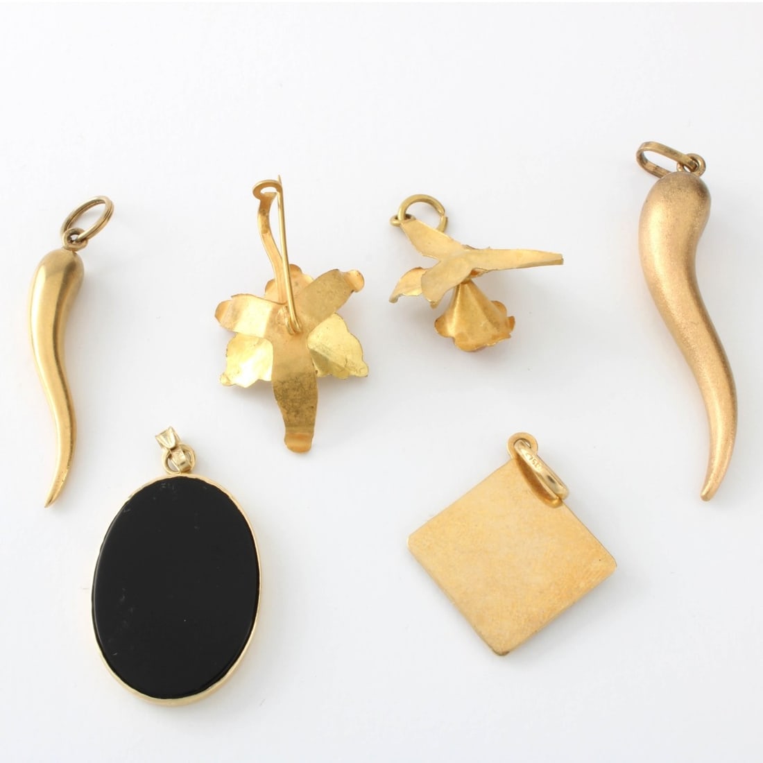 Vintage Gold Pendants: Collection of Six (6) Vintage 14 and 18 Karat Yellow Gold Pendants. One accented with black onyx. All stamped 14K or 18K. Largest measures 1-1/2" L. Approx. total weight: 12.4 grams. Kodner Galleries 