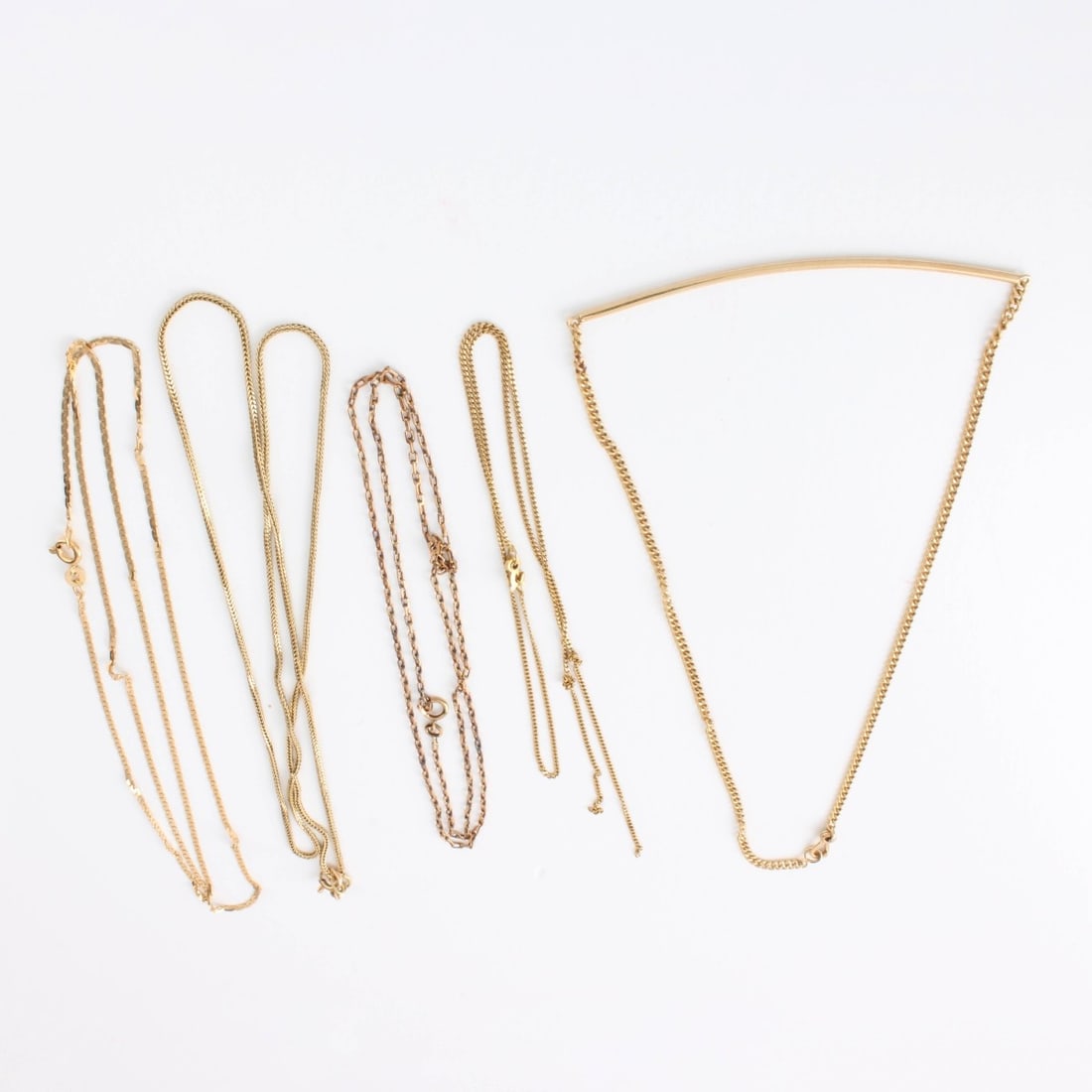14K Gold Necklaces: Collection of Five (5) Vintage Delicate 14 Karat Yellow Gold Chains/ Necklaces. All stamped 14K. Longest measures 22" L. Approx. total weight: 9.15 grams. Kodner Galleries offers phone and absentee bi