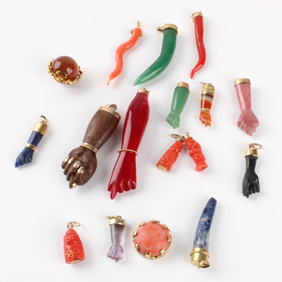 Hardstone Charms and Pendants: Collection of Seventeen (17) Hardstone and Yellow Gold Charms and Pendants. To include coral, lapis lazuli, agate, wood, onyx and nephrite jade mounted in 10K or 14K gold. Largest measures 2-1/2" L.