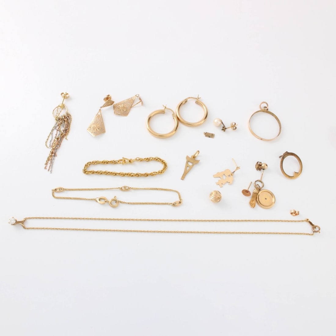 Misc. Scrap Gold Lot: Miscellaneous Scrap Gold Lot. Consisting of 10 karat and 14 karat yellow gold pieces including chains, pendants, earrings and odds and ends. Approx. total weight: 8.45 grams. Kodner Galleries offers