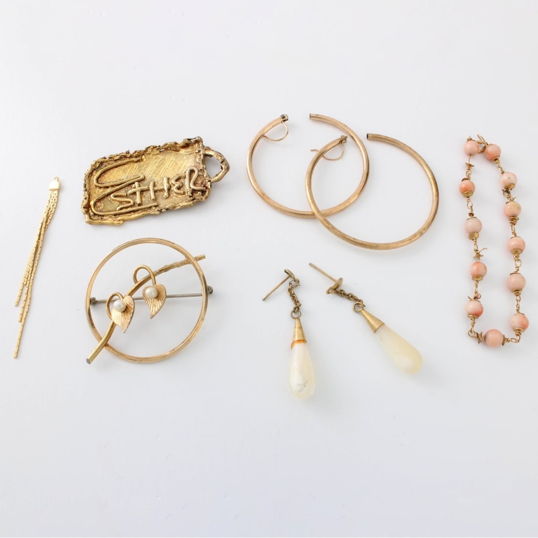 Misc. Scrap Gold Lot: Miscellaneous Scrap Gold Lot. Consisting of 10 karat and 14 karat yellow gold pieces. Largest Esther pin measures 1-1/2 W. Approx. total weight: 10.1 grams. Kodner Galleries offers phone and absentee
