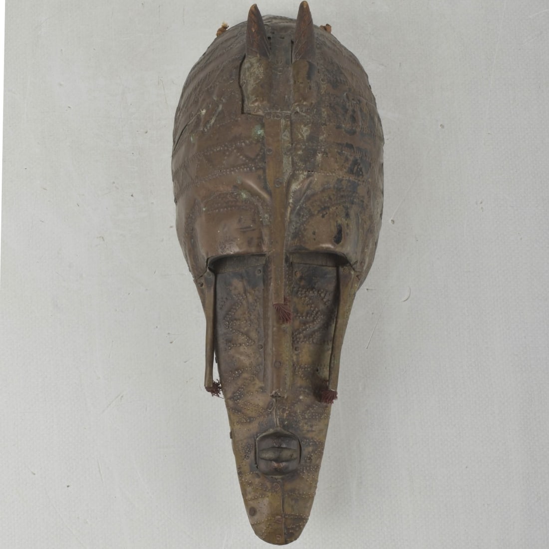 West African Marka Tribal Mask: Vintage Hand Carved and Metal Clad West African Marka Tribal Mask. Measures: 14-1/2" high, 6" wide, 4-1/2" deep. Provenance: From an Important Coconut Grove, Florida Estate. Kodner Galleries offers