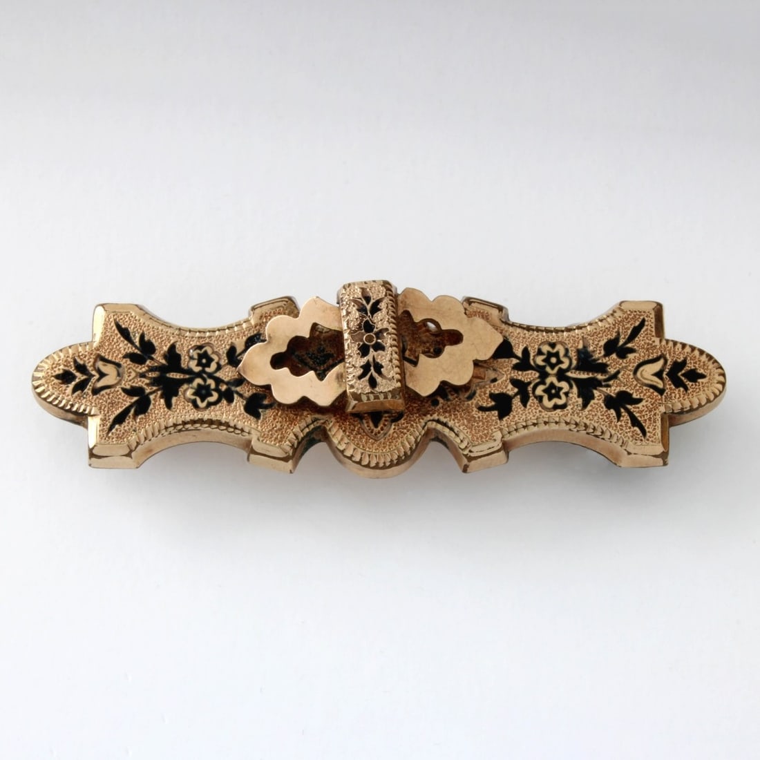Antique 9K Brooch: Antique English 9 Karat Yellow Gold and Enamel Brooch with 14 Karat Yellow Gold Pin Back. Pin closure stamped 14K. Measures 2-3/8" L, 5/8" H. Approx. weight: 11.33 grams. Kodner Galleries offers phone