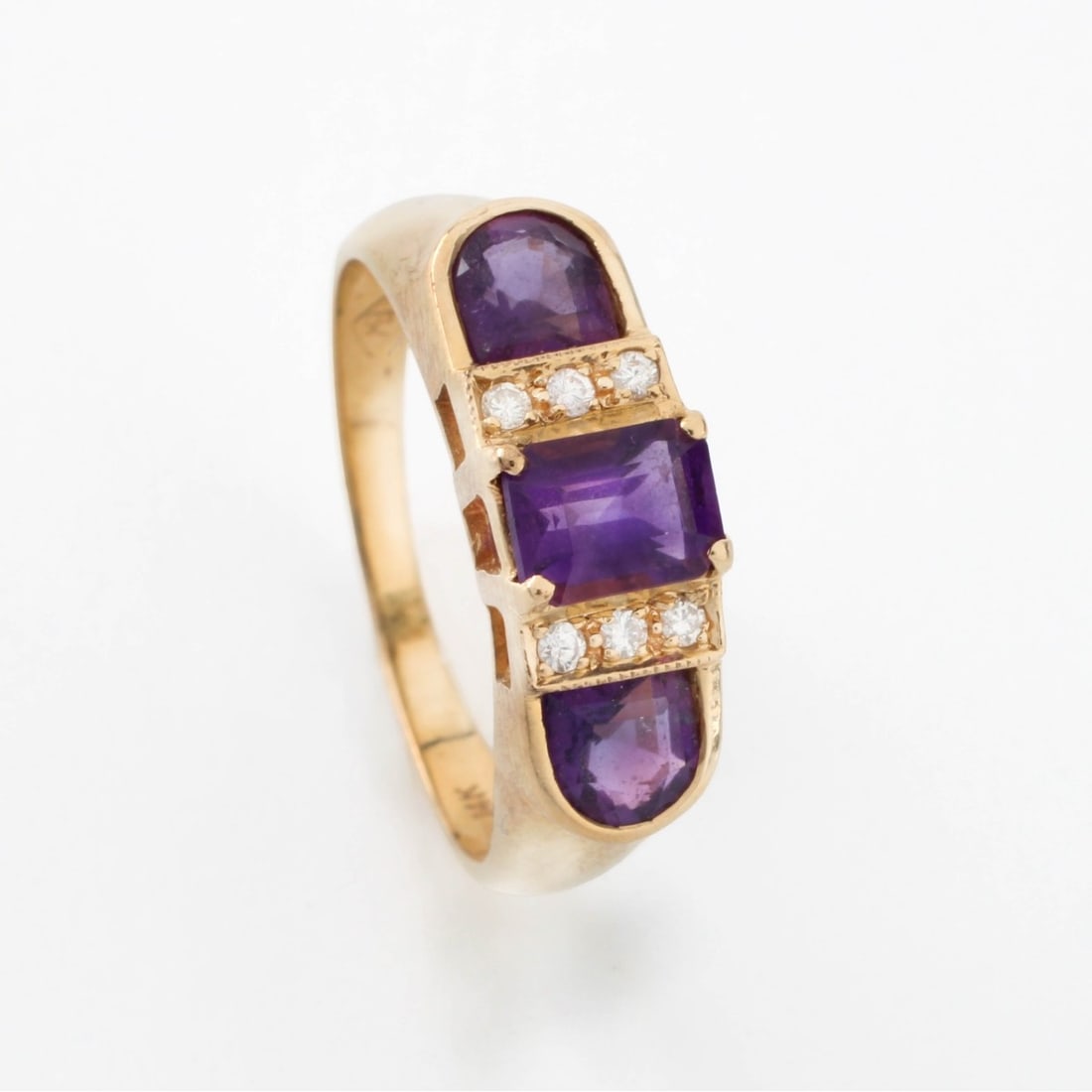Amethyst, Diamond and 14K Ring: Vintage Amethyst and 14 Karat Yellow Gold Three Stone Ring Accented with Small Round Cut Diamonds. Stamped 14K. Ring size 6. Approx. weight: 3.1 grams. Kodner Galleries offers phone and absentee