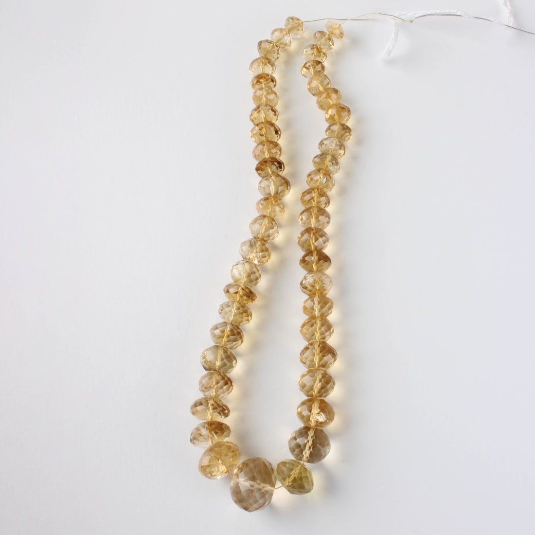 Lemon Quartz Beads: Vintage Single Strand of 465 Carats TW 47 Graduated Lemon Quartz Beads. Range from 10-19mm. Approx. total weight: 93.19 grams. Kodner Galleries offers phone and absentee bidding at a low, flat 21%