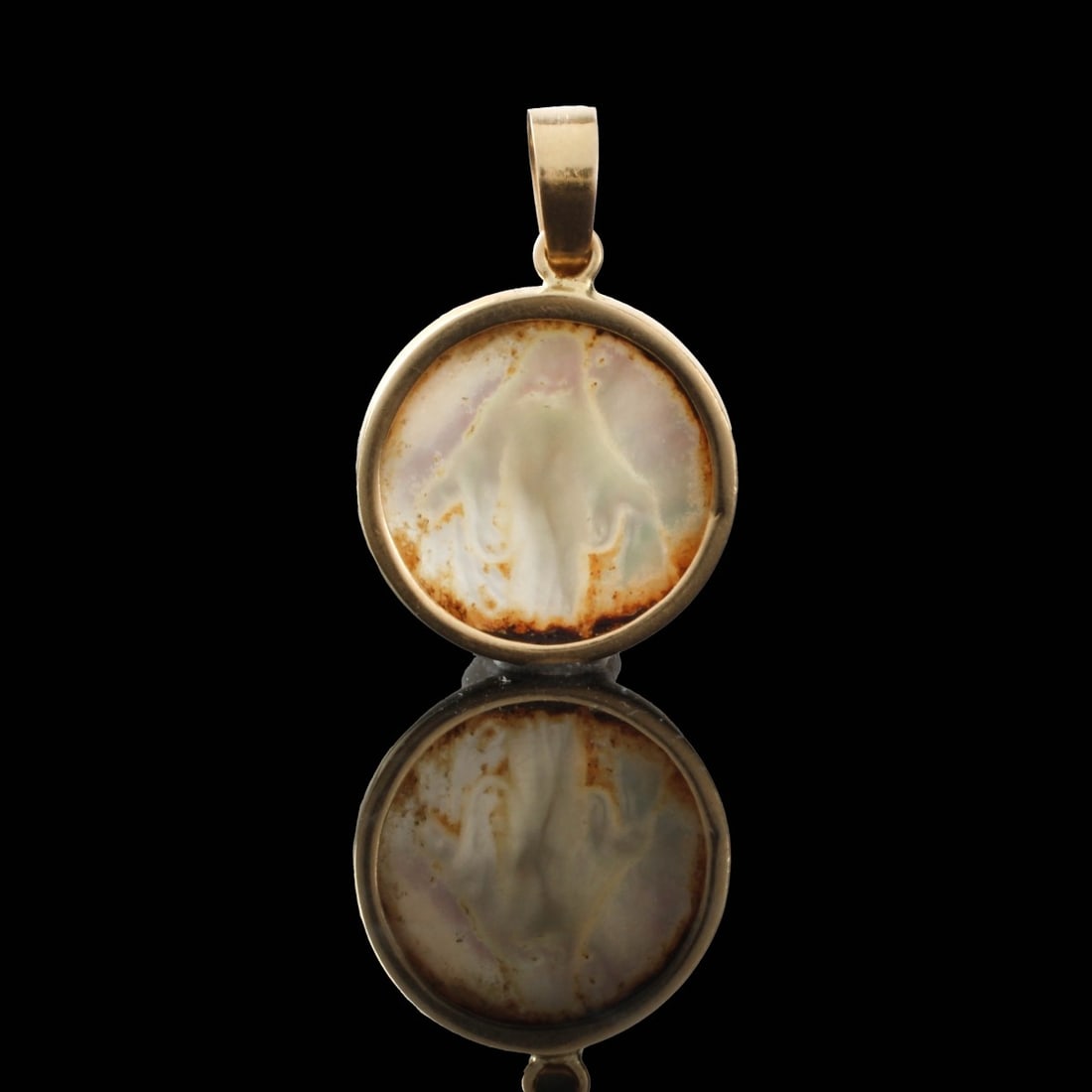 18K and MOP Pendant: Vintage 18 Karat Yellow Gold and Carved Mother of Pearl with Image that Appears to be Christ. Bail stamped 18. Measures 1" L, 5/8" diam. Approx. weight: 1.39 grams. Kodner Galleries offers phone and