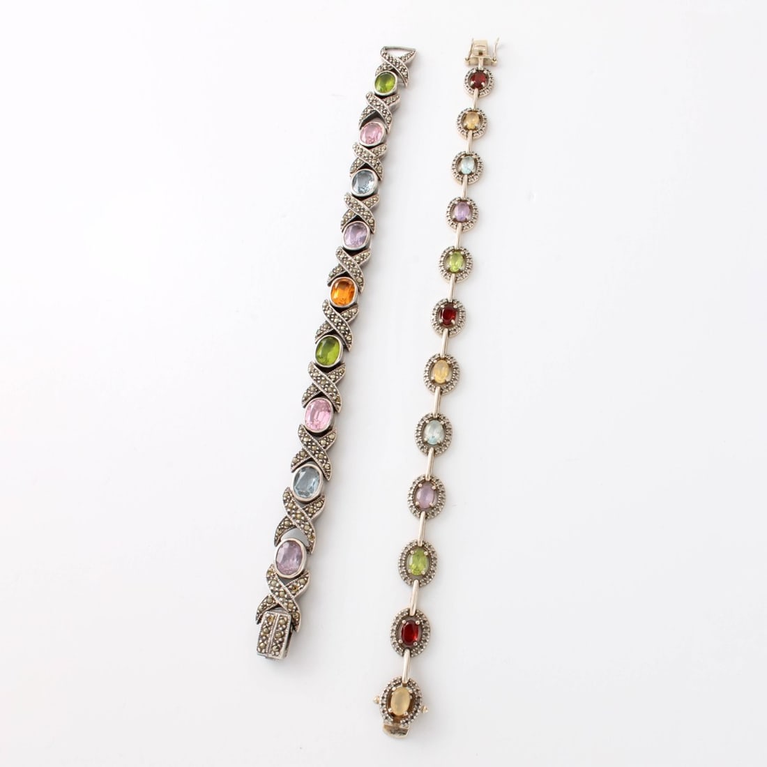 Sterling and Gemstone Bracelets: Two (2) Vintage Sterling Silver and Oval Cut Multi Semi-precious Gemstones. Both with 925 marks. Larger bracelet measures 7" L, 3/8" W. Approx. total weight: 39.41 grams. Kodner Galleries offers