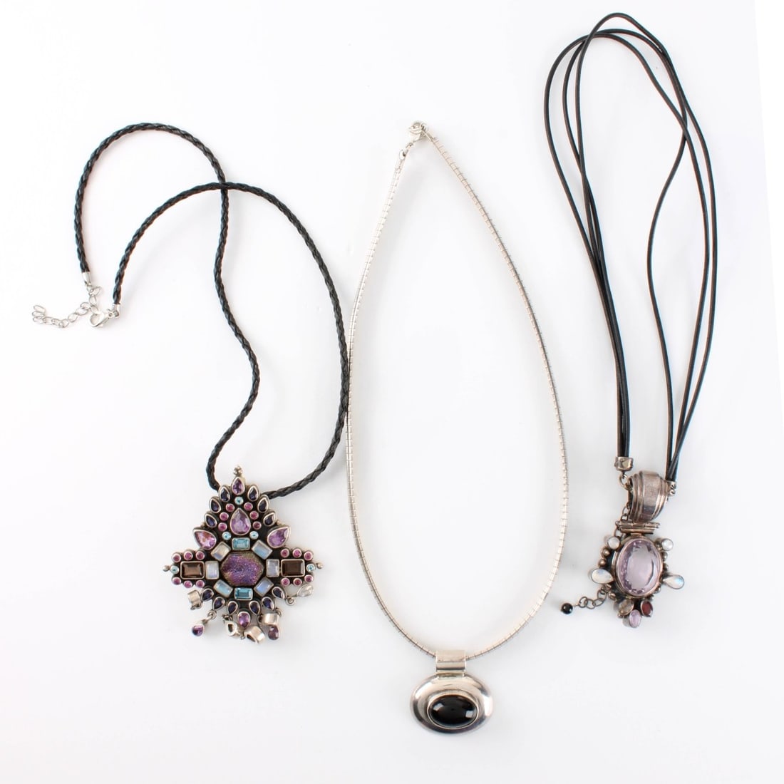 Sterling and Gemstone Necklaces: Three (3) Vintage Sterling Silver and Semi-precious Gemstone and Hardstone Pendant Necklaces. Two with leather cord chains/. Largest pendant can also be worn as a brooch. Largest pendant measures 3" L