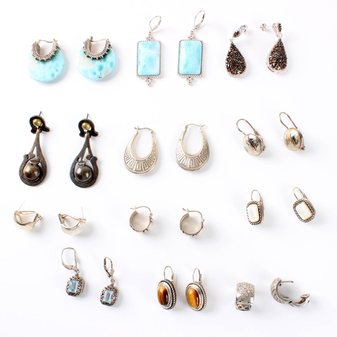 Sterling Earrings: Fourteen(14) Pair of Sterling Silver Earrings. Variously accented with color stones, faux diamonds and hardstones. Largest pair measure 2" L, 5/8" W. Approx. total weight: 104.40 grams. Condition: