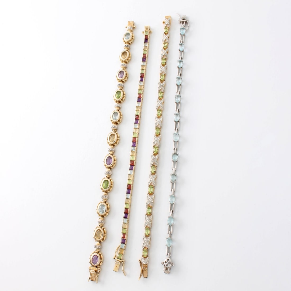 Sterling and Gemstone Bracelets: Four (4) Sterling Silver Vermeil and Multi Color Semi Precious Gemstone Bracelets. Largest measures 7-1/8" L, 3/8" W. Approx. total weight: 43.11 grams. Condition: Good condition. Each piece not