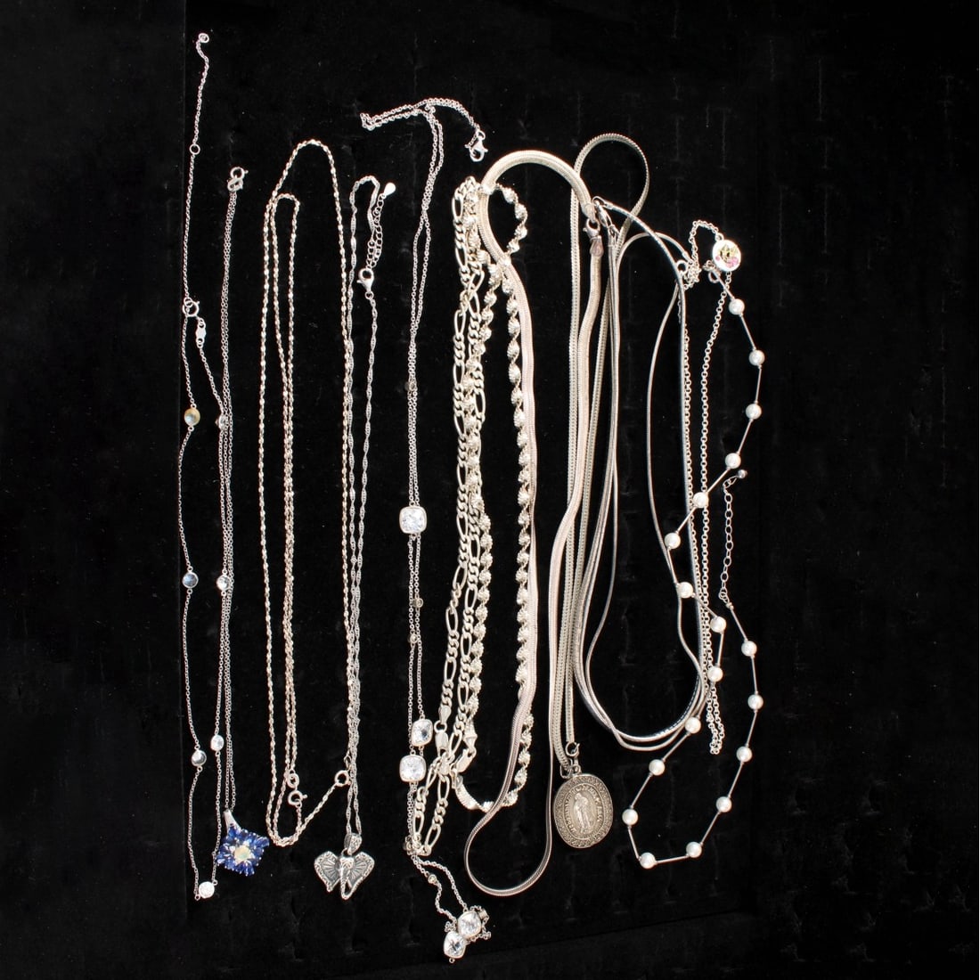 Sterling Chains / Necklaces: Collection of Fourteen (14) Sterling Silver Link Chains / Necklaces. Four with pendants. A few set with color stones and faux diamonds. Longest measures 36" L. Approx. total weight: 156.60 grams. Cond