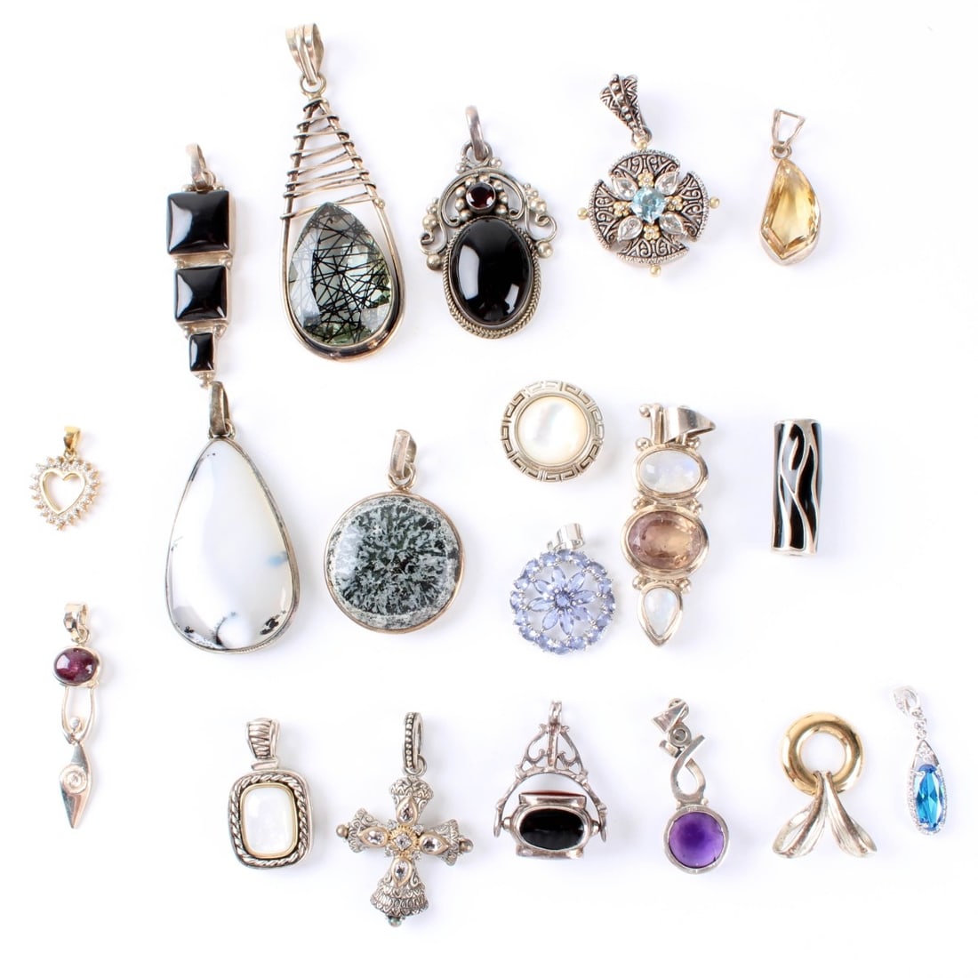 Sterling Pendants: Nineteen (19) Sterling Silver Pendants. Variously accented with hardstones, color stones and enamel. Approx. total weight: 182.77 grams. Condition: Good condition. Each piece not examined in detail.