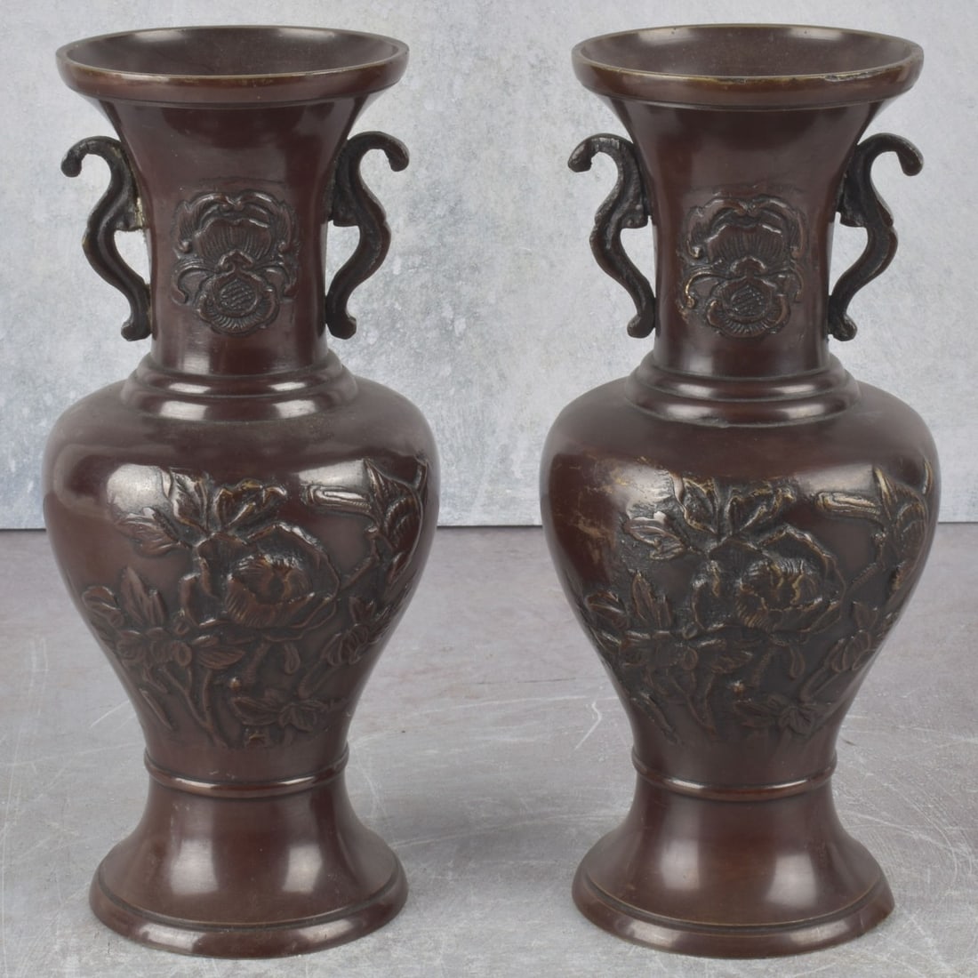 Pair of Japanese Bronze Vases: Pair of Japanese Bronze Vases with Attached Handles. Decorated with flowers and birds. Measures: 7-3/4" high, 3-1/4" diameter. Kodner Galleries offers phone and absentee bidding at a low, flat 21%