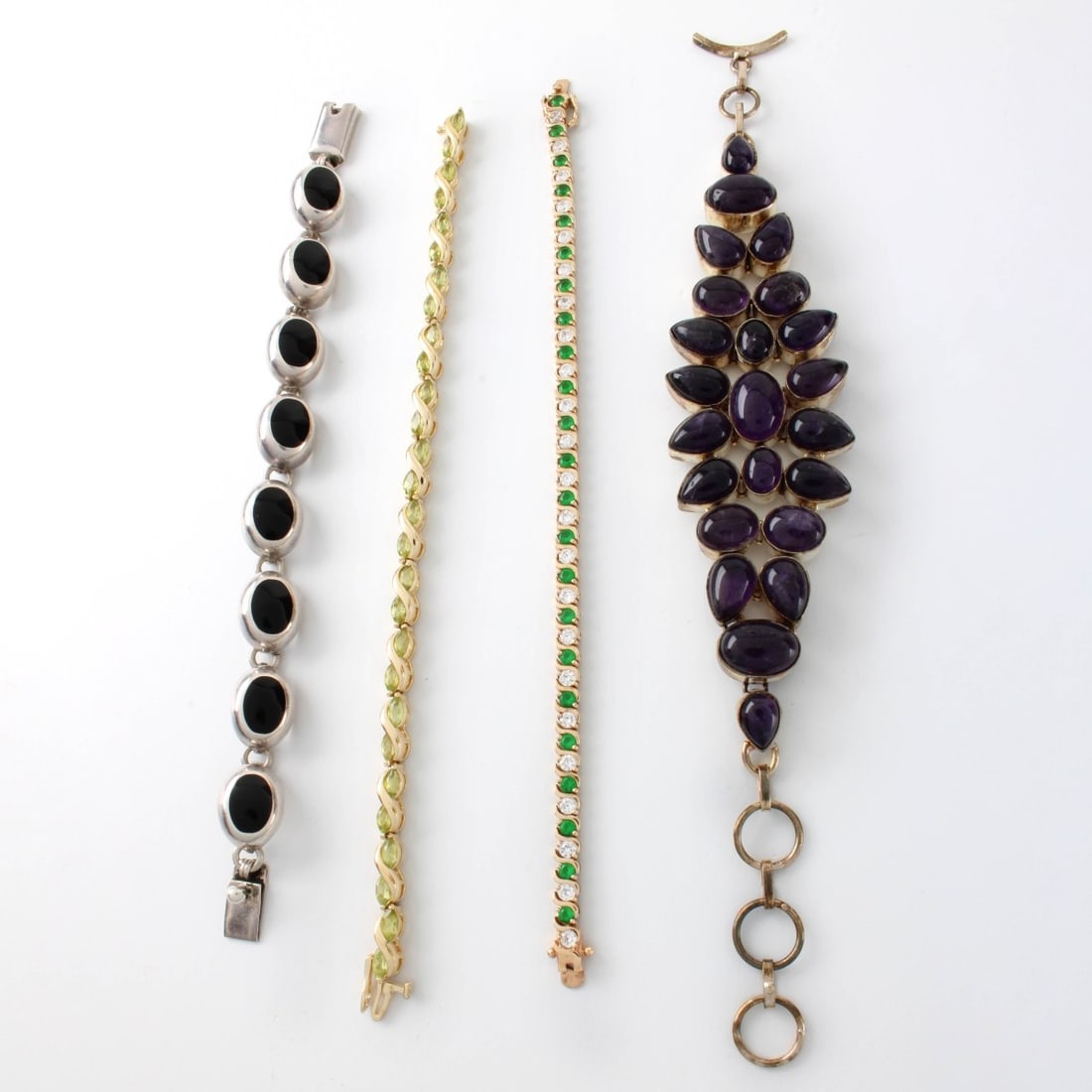 Sterling Bracelets: Four (4) Vintage Sterling Silver Bracelets. Various set with amethysts, black onyx, peridot, green stones and faux diamonds. Amethyst bracelet measures 8" L. 1-1/4" W. Approx. total weight: 107.33