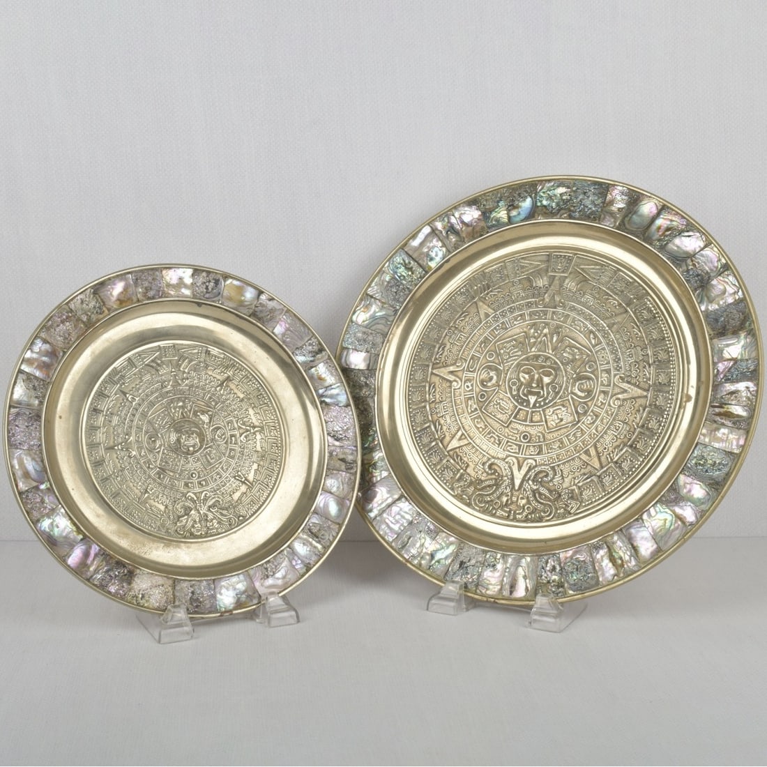 Mexican Silver Plates: Two (2) Vintage Mexican Silver Hanging Wall Plates. Largest measures: 13-5/8" diameter, smallest measures: 11" diameter. PROVENANCE: From an avid collector and long-term resident living in Congo.