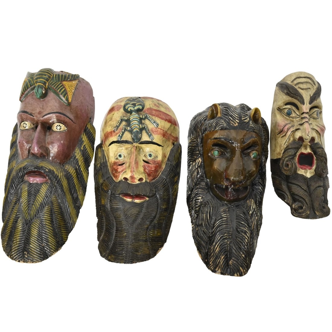 Hand Carved and Painted Guatemalan Masks: Collection of Four (4) Hand Carved and Painted Guatemalan Masks. Largest measures: 23" high, 10-1/2" wide, 7" deep. Kodner Galleries offers phone and absentee bidding at a low, flat 21% buyer?s