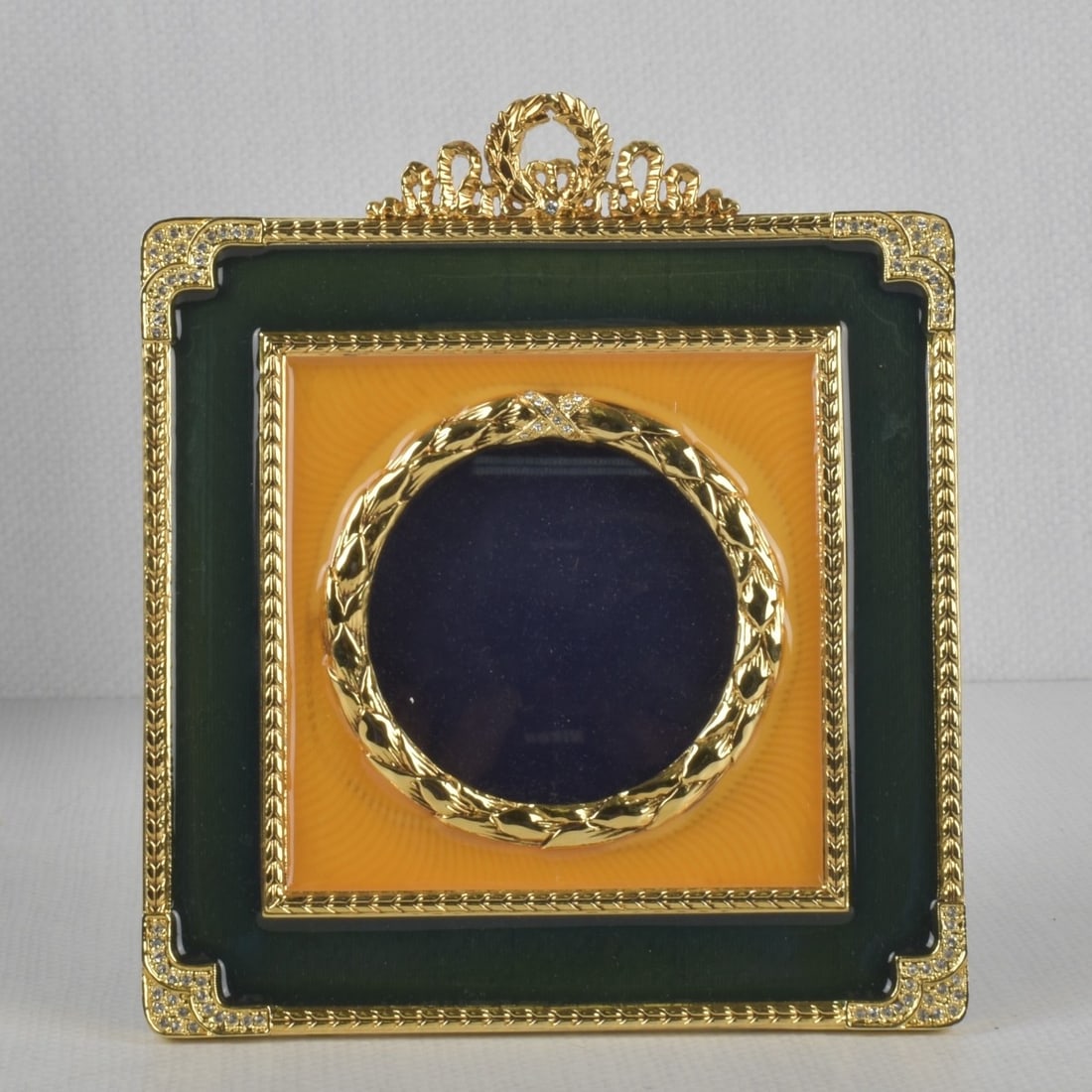 Faberge Picture Frame: Faberge Gilt Metal and Enamel Square Picture Frame with Original Decorative Box. Frame measures: 6-3/4" high, 5-3/4" wide, round glass measures: 2-5/8" diameter. Kodner Galleries offers phone and abse