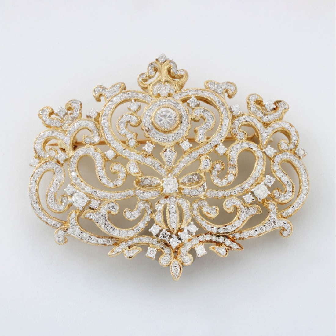 Diamond and 18K Pendant / Brooch: Vintage Diamond and 18 Karat Yellow Gold Pendant Brooch. Set with numerous round brilliant cut diamonds, F-G color, VS-SI clarity. Measures 1-1/3" H, 1-7/8" W. Stamped 750 18K. Approx. weight: 14.93 g
